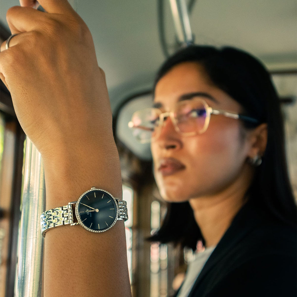 A small watch with an arctic sunray watch with silver 5-link strap